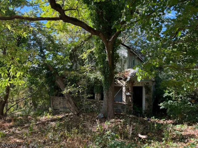 a yellow house with lots of trees