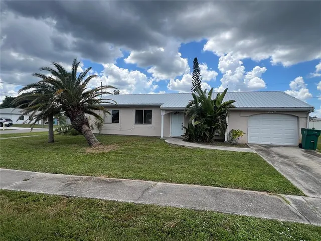 a front view of a house with a garden and yard