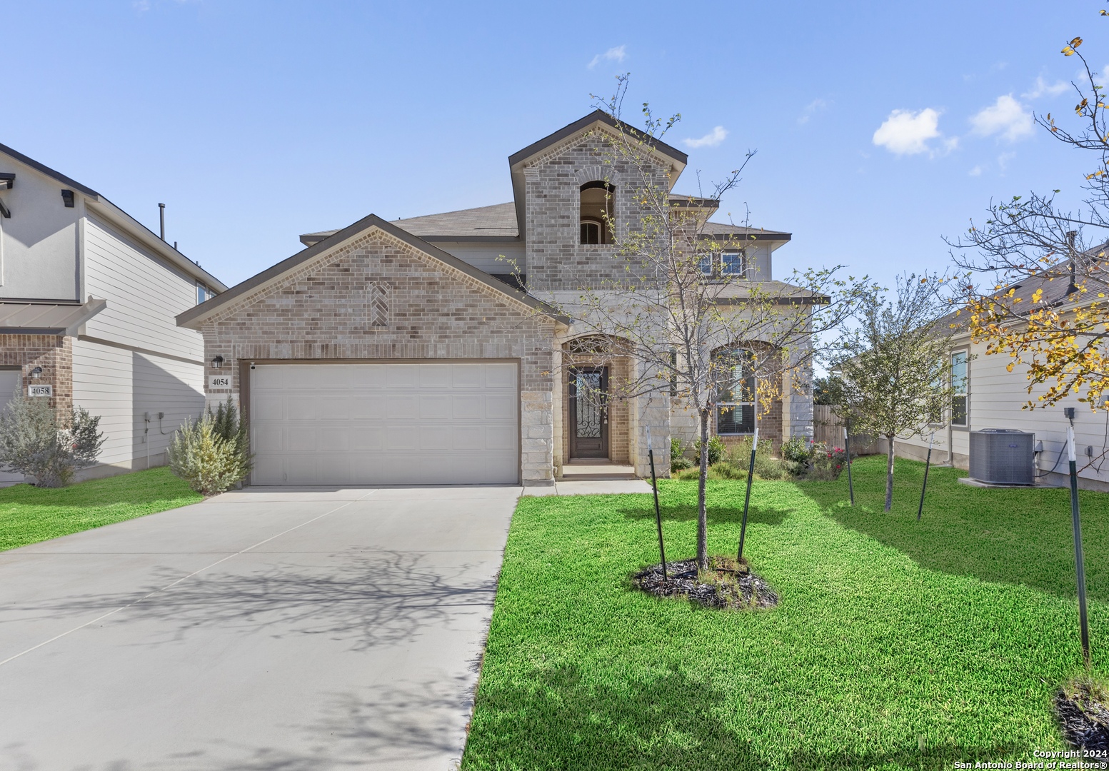 a front view of a house with a garden