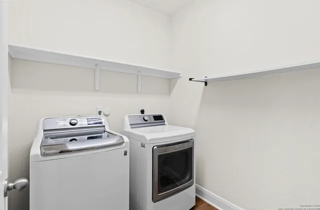 a view of washer and dryer with kitchen in the background