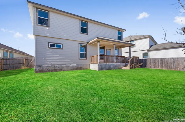 a front view of house with yard and outdoor seating
