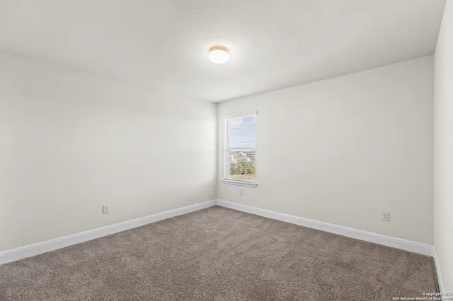 an empty room with a empty space and windows