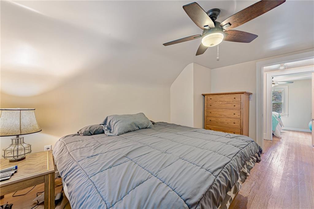 843 Brush Creek Road Penn, PA 15675 - Photo 18 of 22 a bedroom with a bed and a chandelier