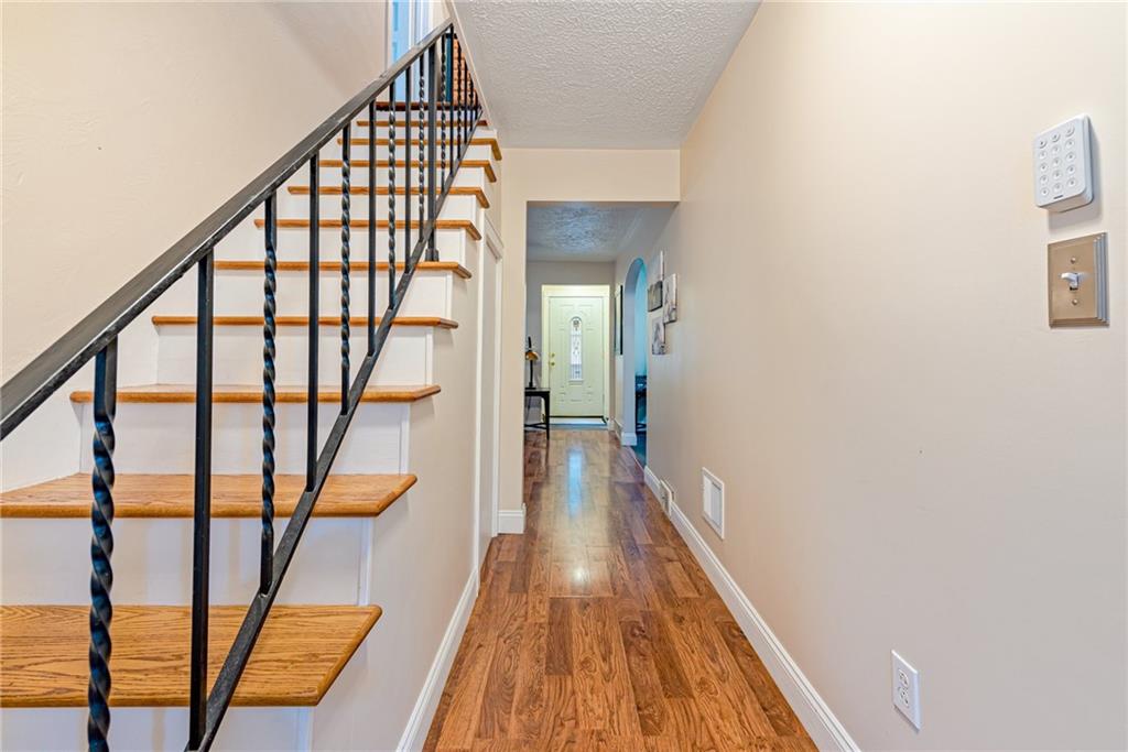 843 Brush Creek Road Penn, PA 15675 - Photo 20 of 22 a view of entryway with wooden floor and stairs
