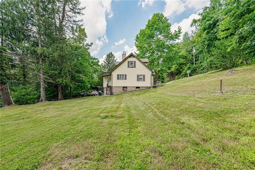 843 Brush Creek Road Penn, PA 15675 - Photo 3 of 22 a large house with a big yard and large trees
