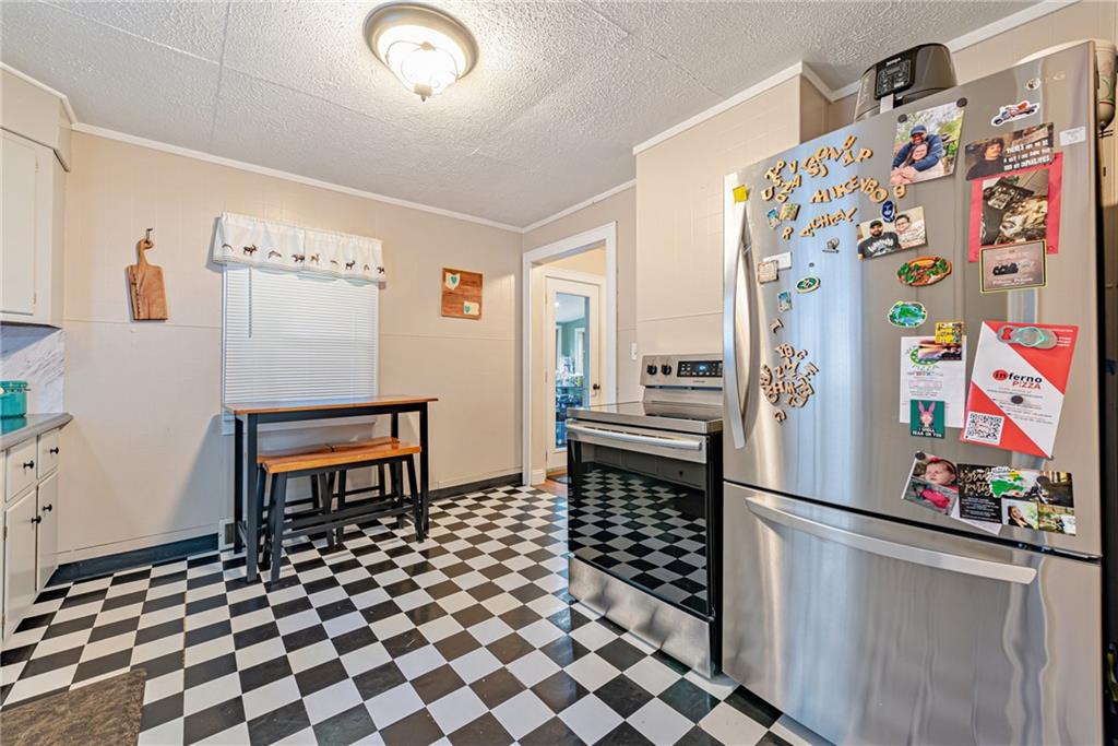 843 Brush Creek Road Penn, PA 15675 - Photo 4 of 22 a kitchen with stainless steel appliances granite countertop a refrigerator and a stove top oven