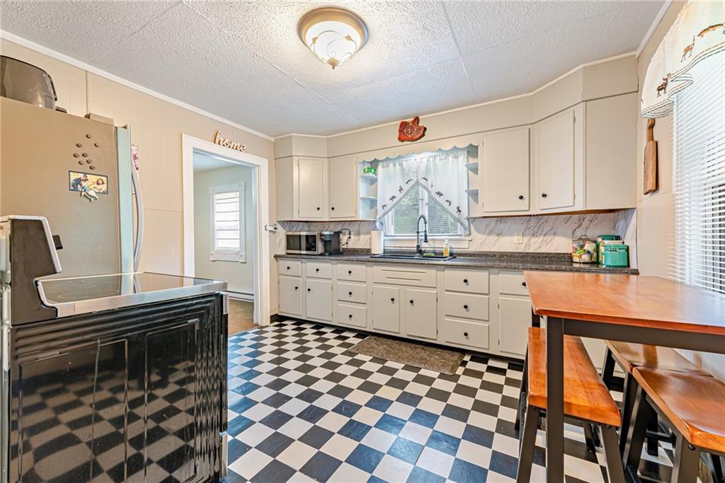 843 Brush Creek Road Penn, PA 15675 - Photo 5 of 22 a kitchen with stainless steel appliances a stove a sink and a refrigerator