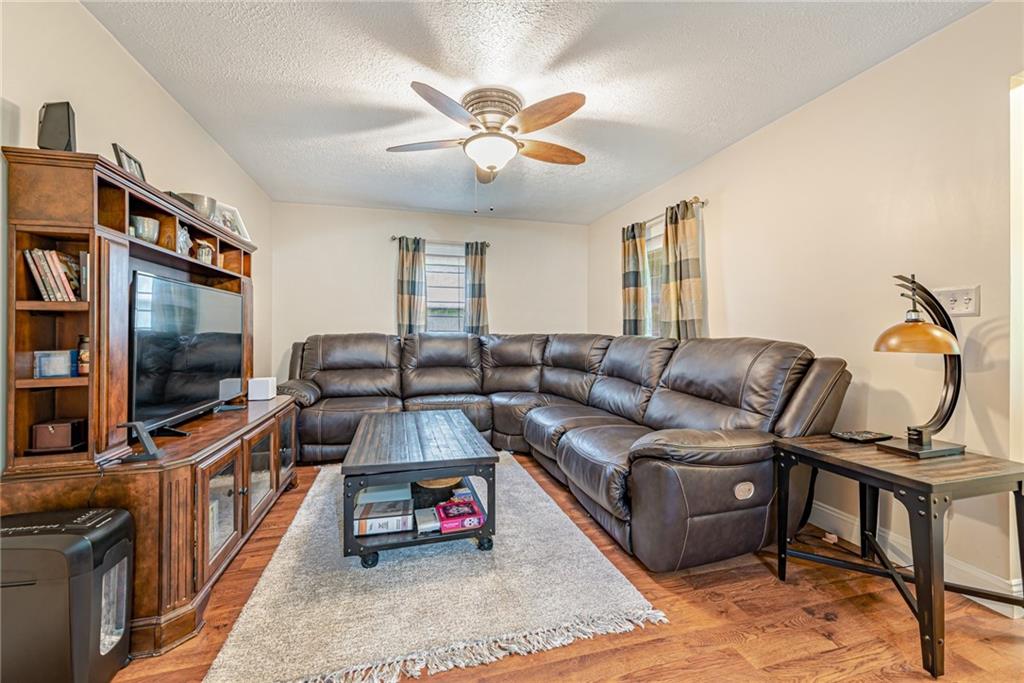 843 Brush Creek Road Penn, PA 15675 - Photo 6 of 22 a living room with furniture and a flat screen tv