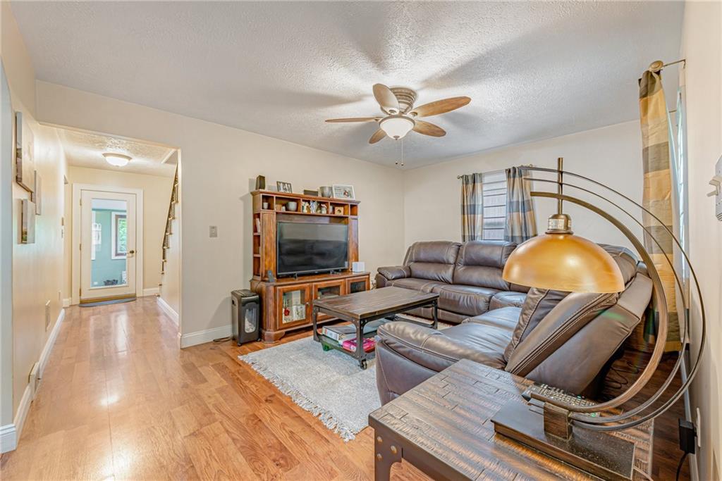 843 Brush Creek Road Penn, PA 15675 - Photo 7 of 22 a living room with furniture and a flat screen tv