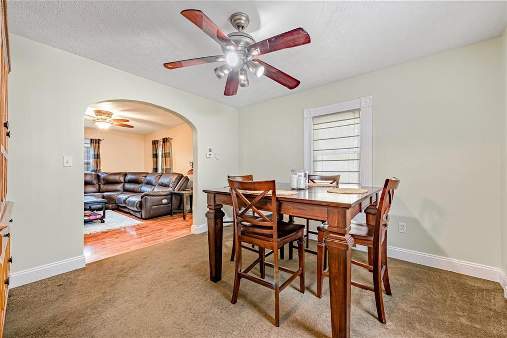 843 Brush Creek Road Penn, PA 15675 - Photo 8 of 22 a view of a dining room with furniture and a chandelier fan