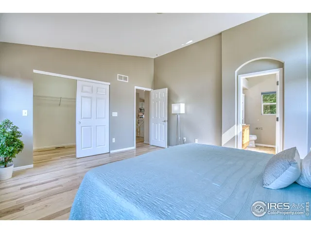 a bathroom with a granite countertop sink a toilet a mirror and shower