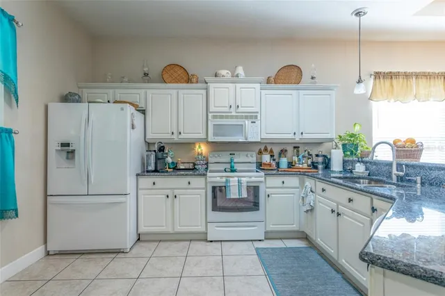a kitchen with appliances cabinets and a sink