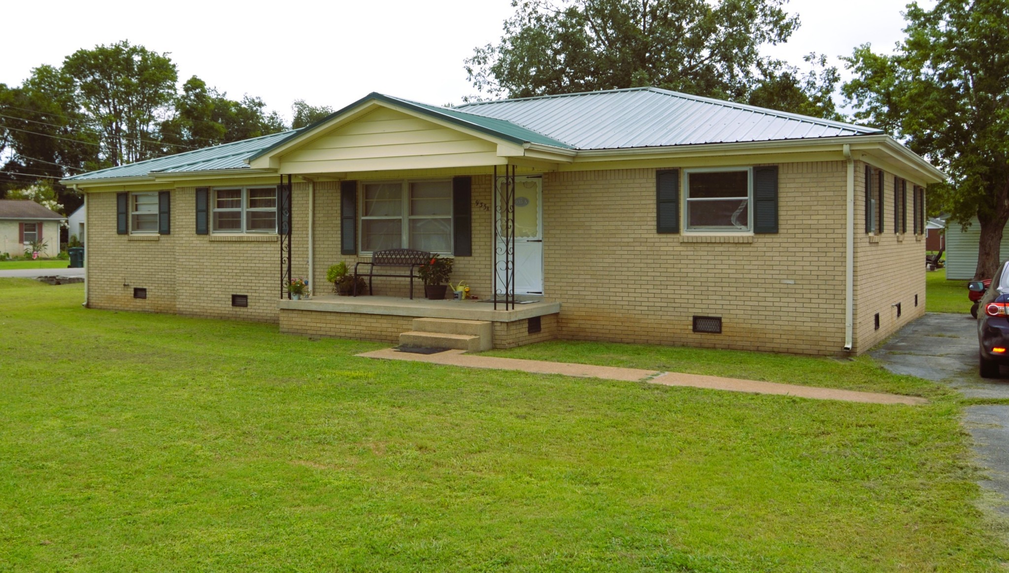a front view of a house with a garden and porch