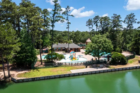 a view of a house with swimming pool and a yard