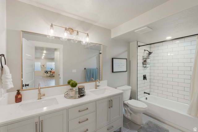 2319 North 3370 West Lehi, UT 84048 - Photo 20 of 30 Bathroom featuring a dual vanity with light gray cabinetry, brushed gold fixtures, and a spacious mirror