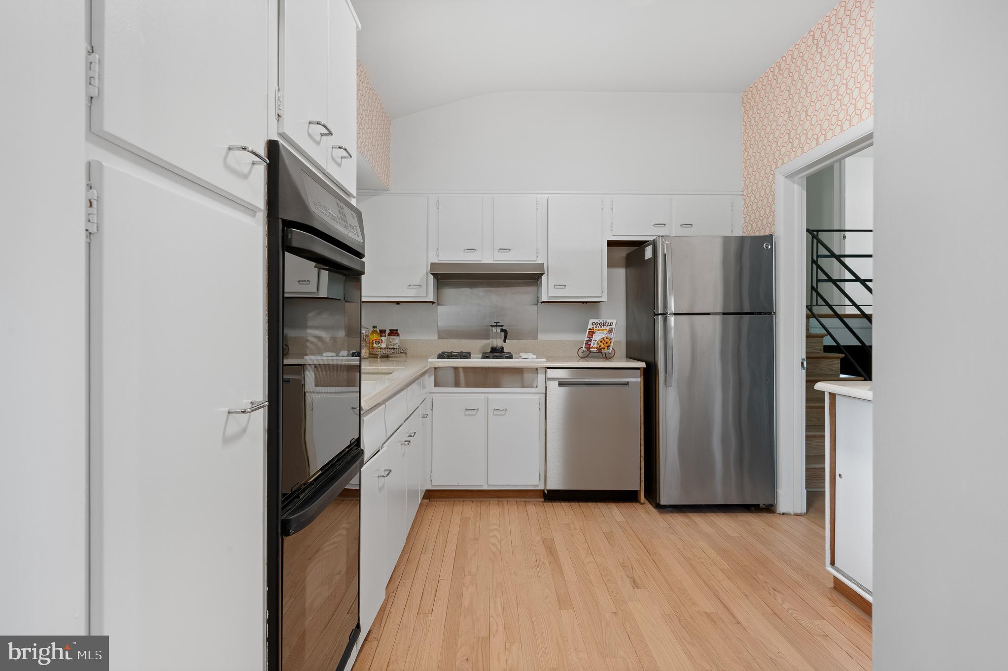 1006 Strout Street Silver Spring, MD 20901 - Photo 15 of 54 a kitchen with a refrigerator a sink and cabinets