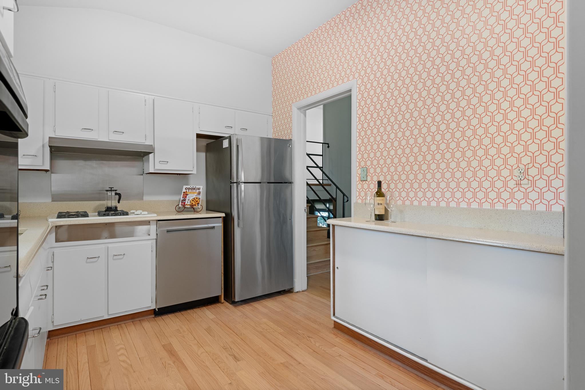 1006 Strout Street Silver Spring, MD 20901 - Photo 16 of 54 a kitchen with white cabinets and white appliances