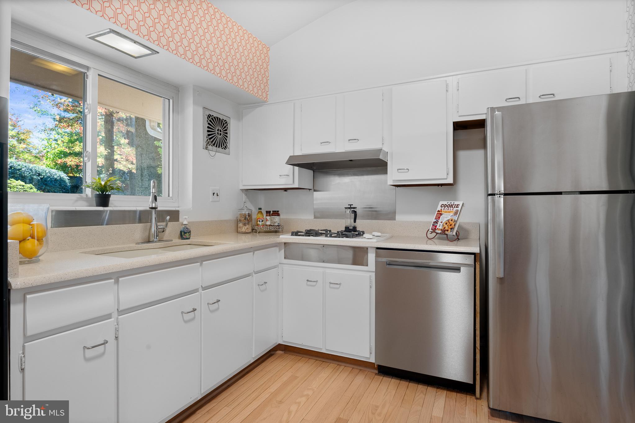 1006 Strout Street Silver Spring, MD 20901 - Photo 17 of 54 a kitchen with a sink a refrigerator and white cabinets