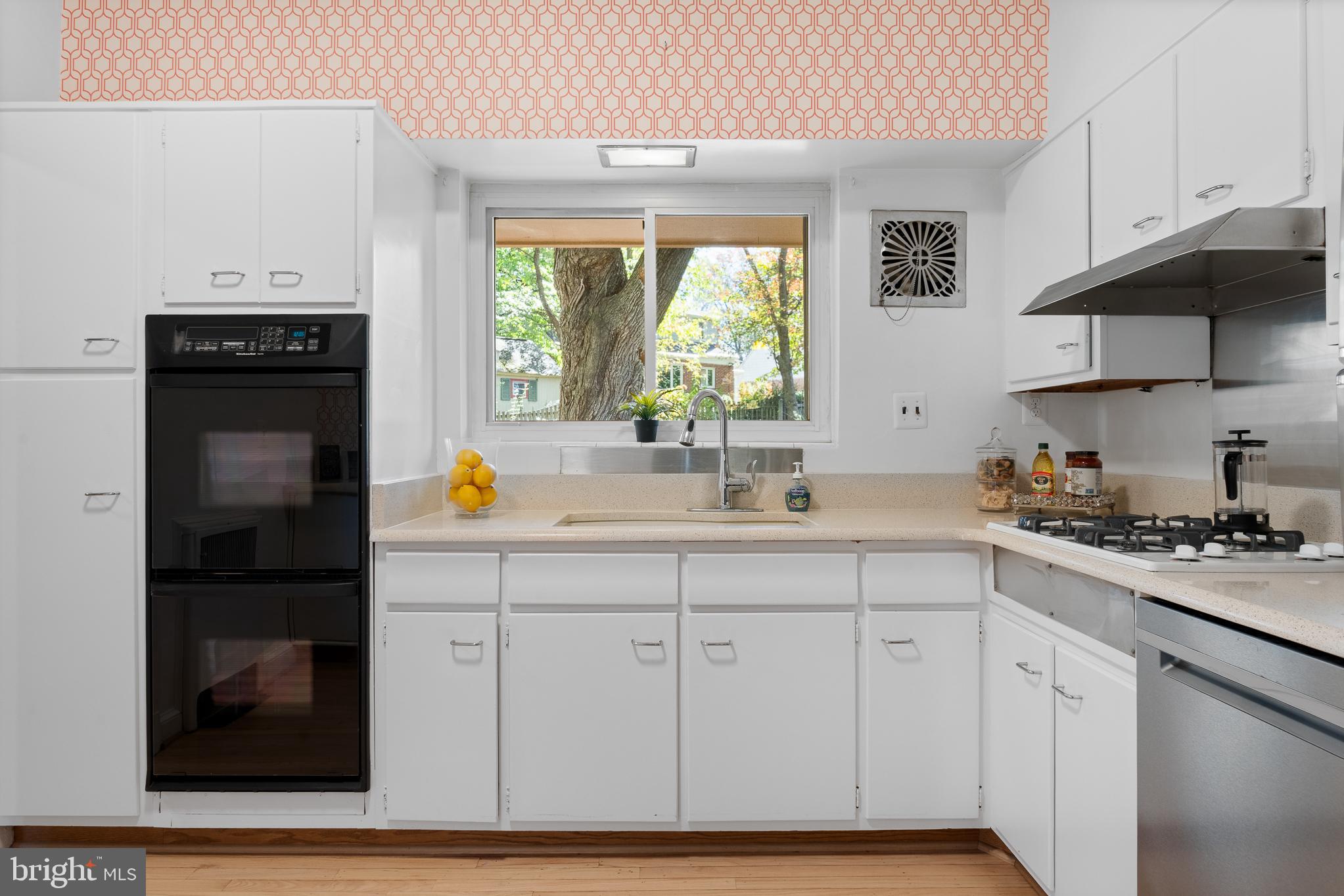 1006 Strout Street Silver Spring, MD 20901 - Photo 18 of 54 a kitchen with white cabinets and appliances