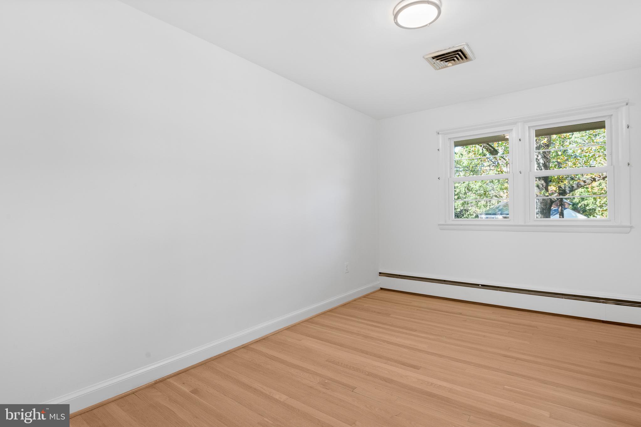 1006 Strout Street Silver Spring, MD 20901 - Photo 28 of 54 a view of an empty room with wooden floor and a window