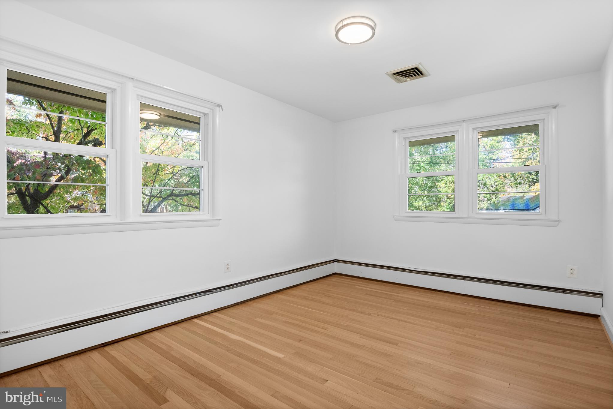 1006 Strout Street Silver Spring, MD 20901 - Photo 37 of 54 a view of an empty room with wooden floor and a window