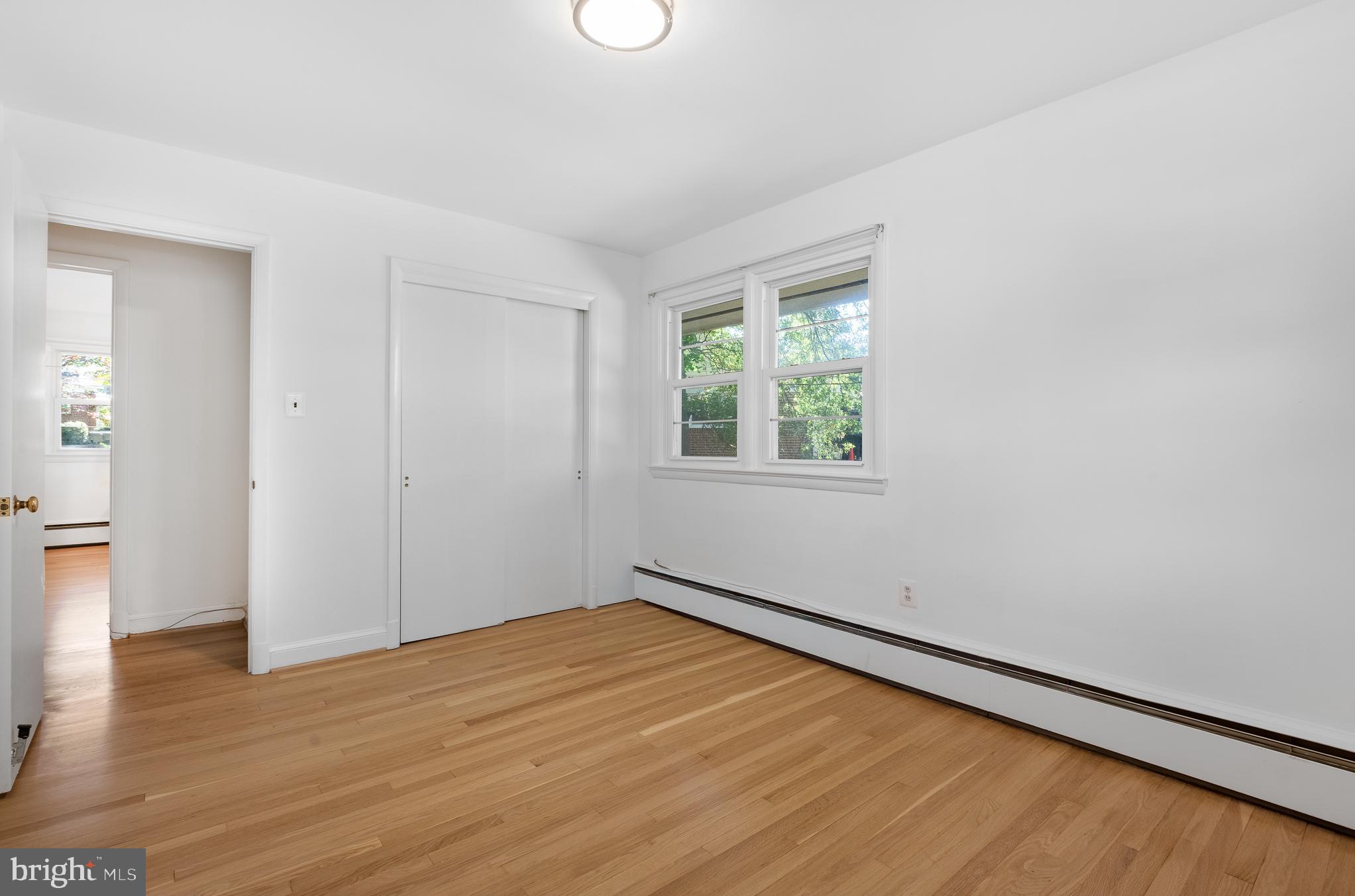 1006 Strout Street Silver Spring, MD 20901 - Photo 38 of 54 an empty room with wooden floor and windows