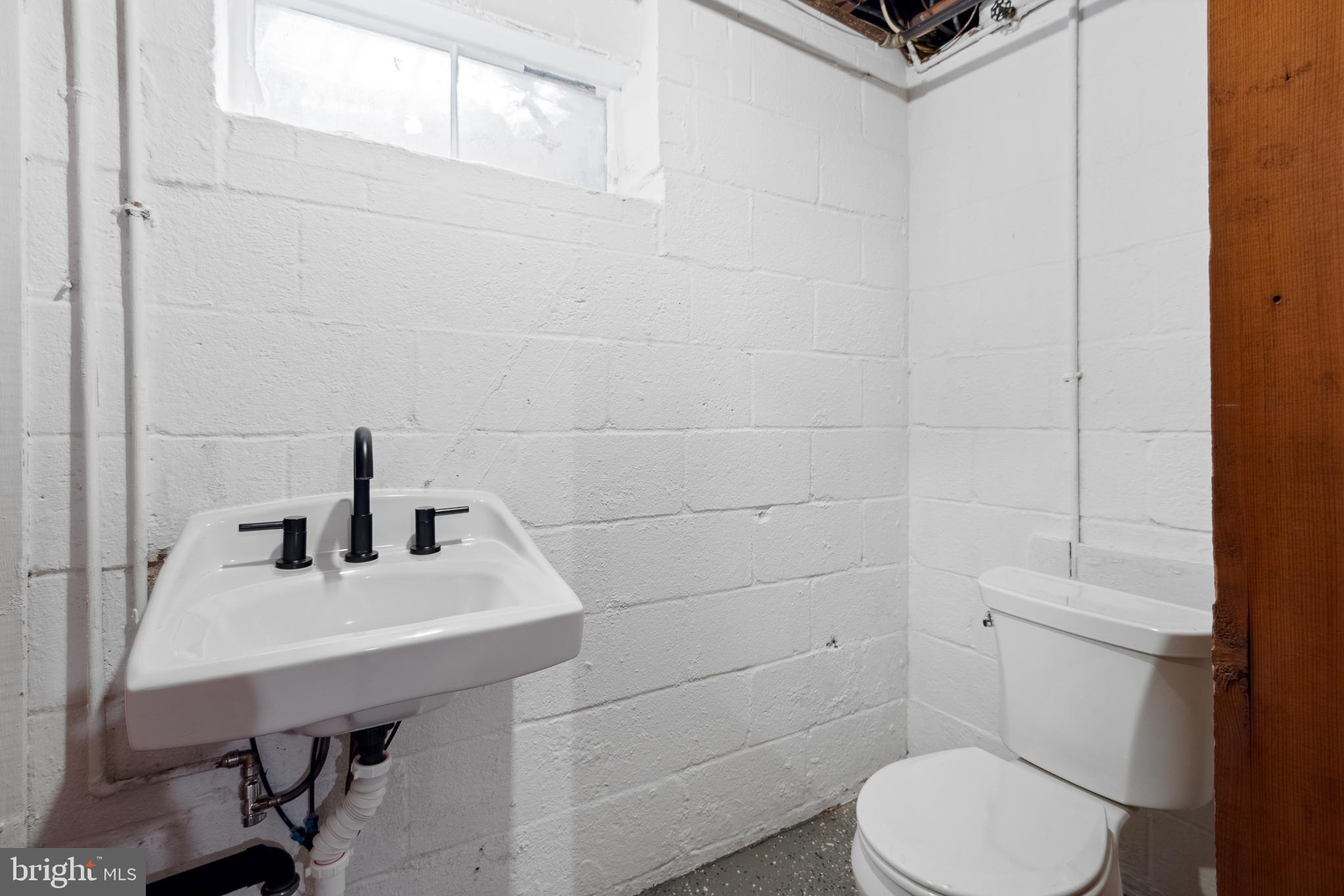 1006 Strout Street Silver Spring, MD 20901 - Photo 45 of 54 a bathroom with a sink a toilet and mirror
