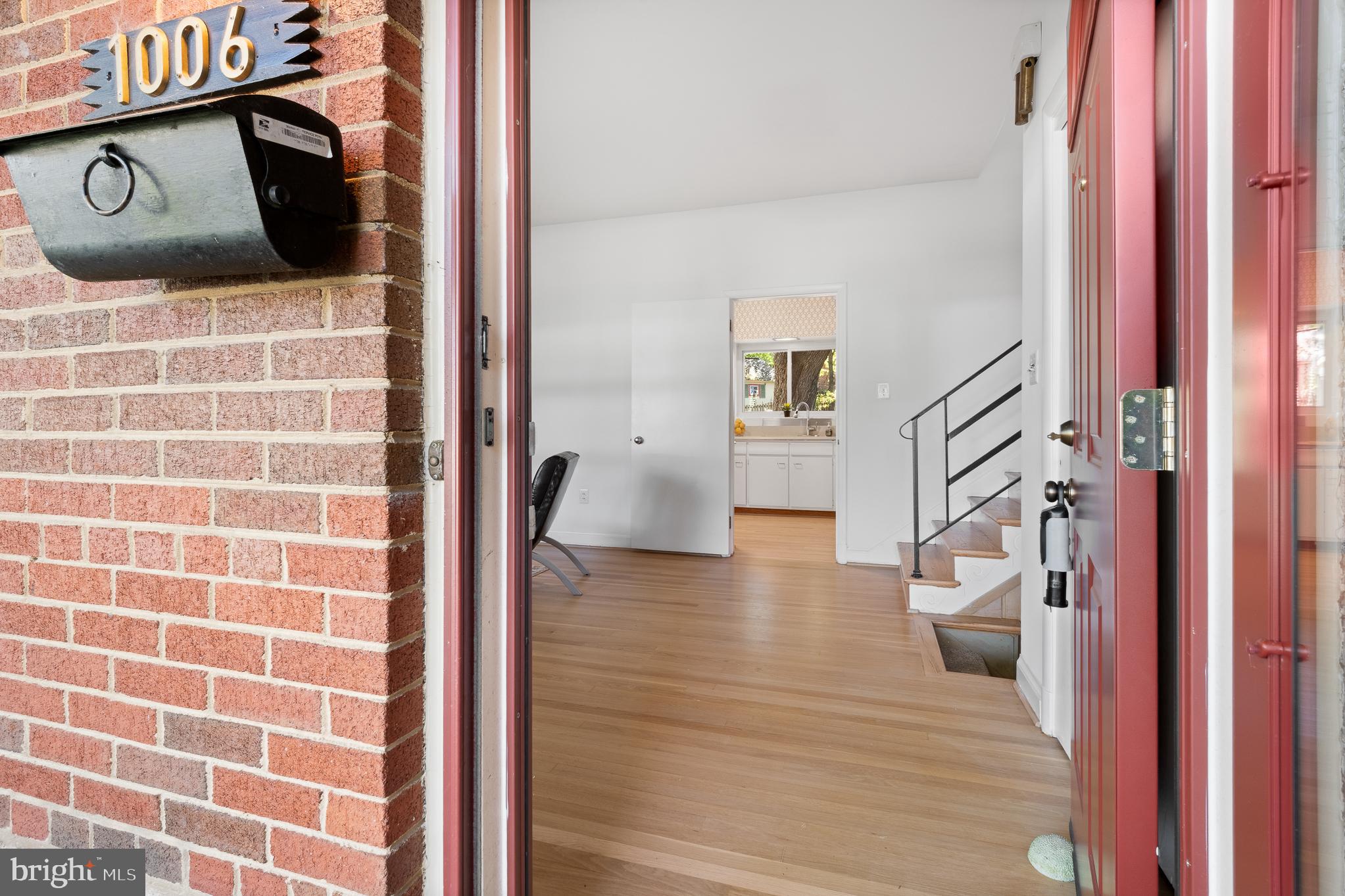 1006 Strout Street Silver Spring, MD 20901 - Photo 6 of 54 a view of a hallway with wooden floor and furniture
