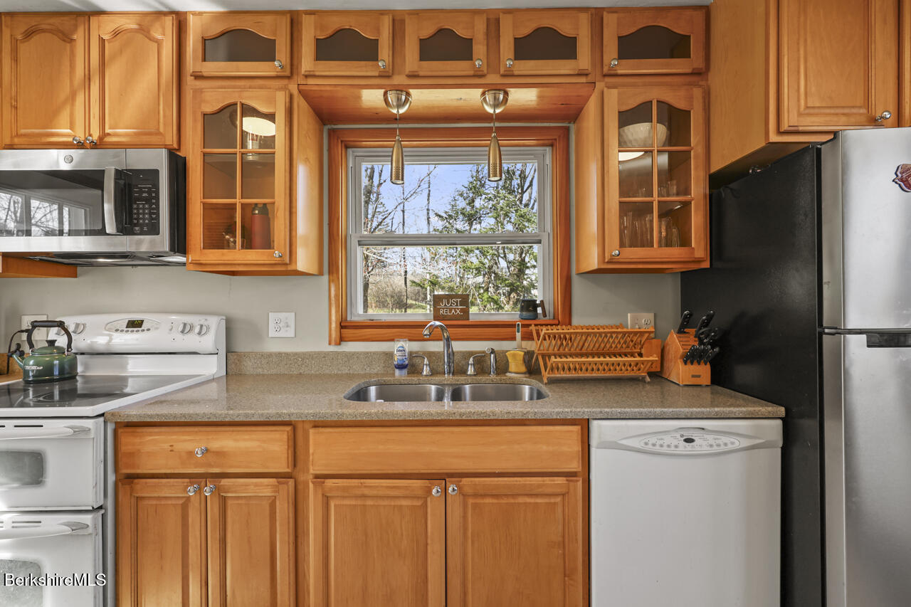 31 New Windsor Road Hinsdale, MA 01235 - Photo 7 of 15 a kitchen with stainless steel appliances granite countertop a sink and a refrigerator