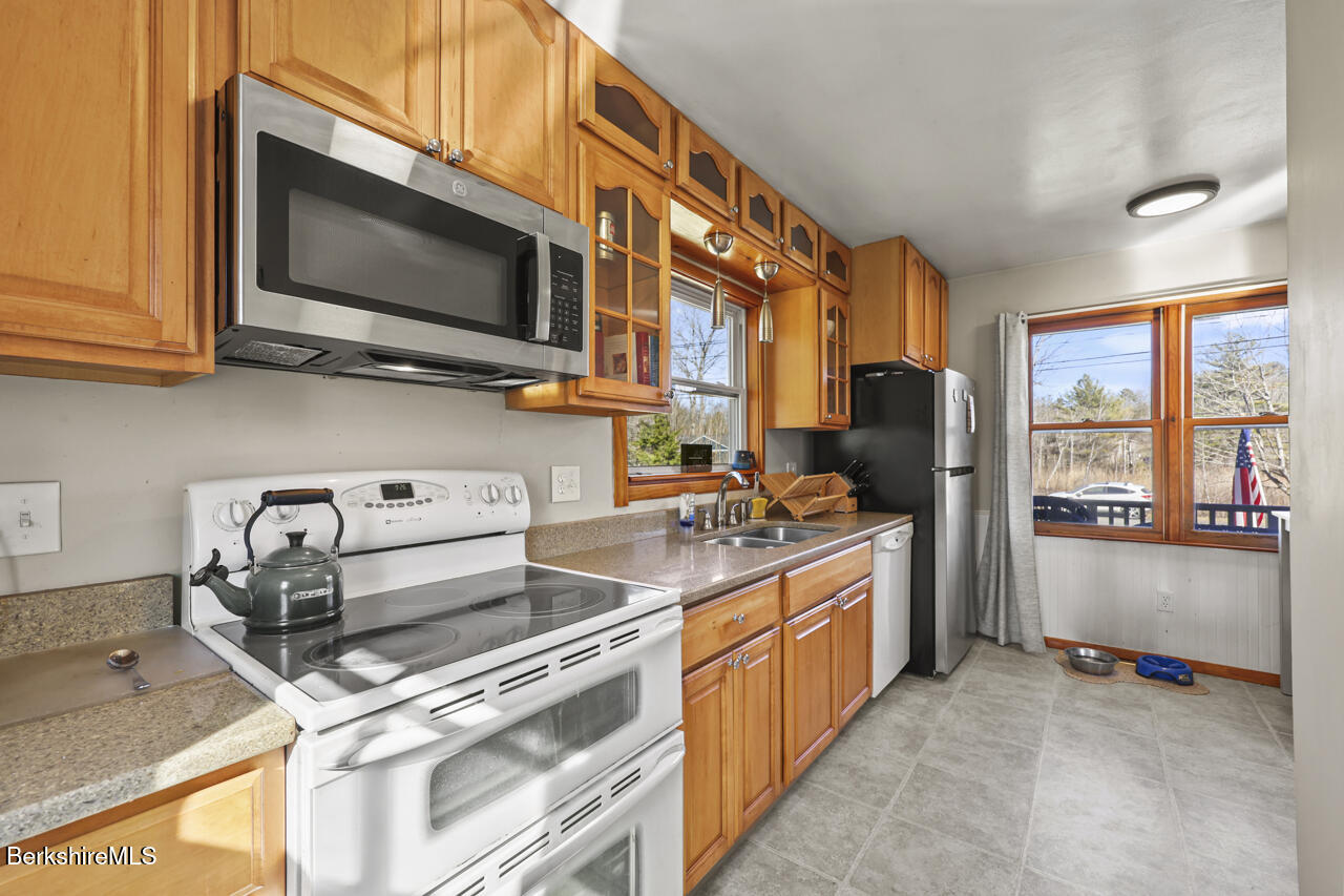 31 New Windsor Road Hinsdale, MA 01235 - Photo 8 of 15 a kitchen with stainless steel appliances granite countertop a stove and a microwave