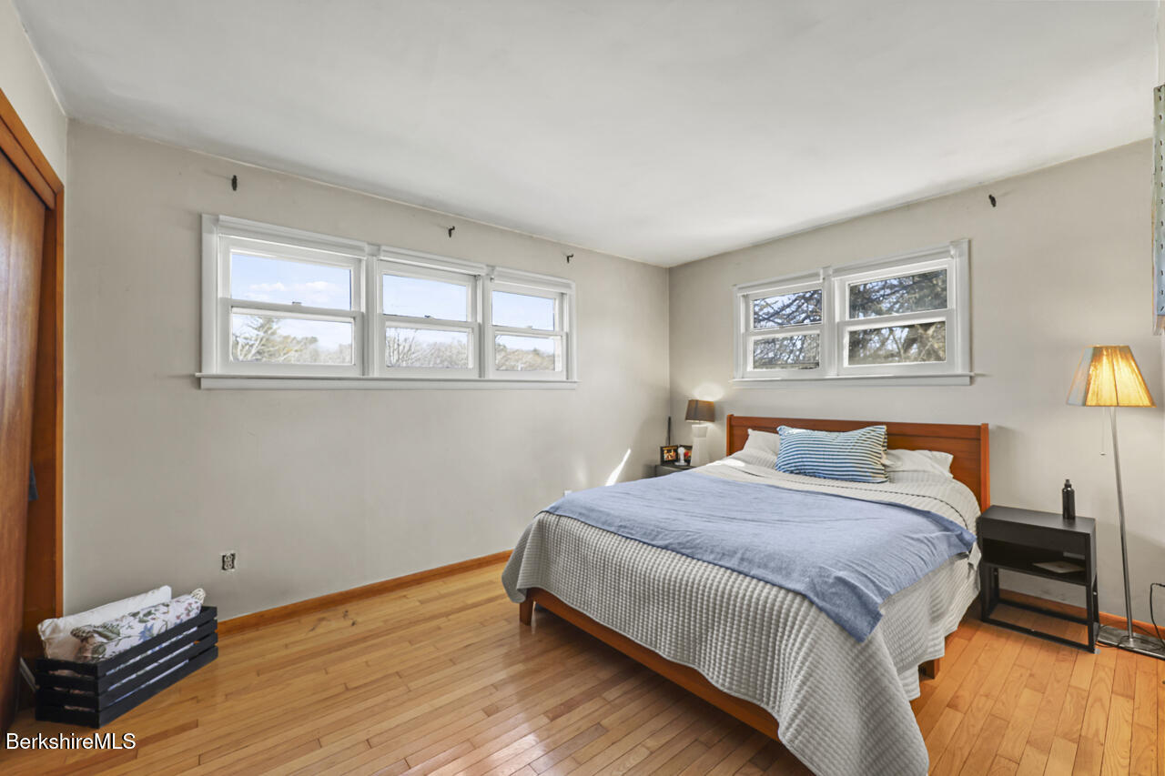 31 New Windsor Road Hinsdale, MA 01235 - Photo 9 of 15 a bedroom with a bed and wooden floor