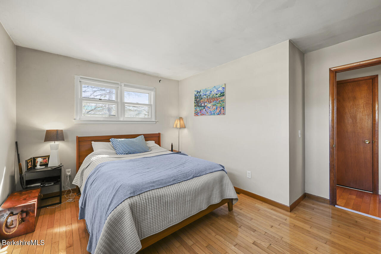 31 New Windsor Road Hinsdale, MA 01235 - Photo 10 of 15 a bedroom with a bed and wooden floor
