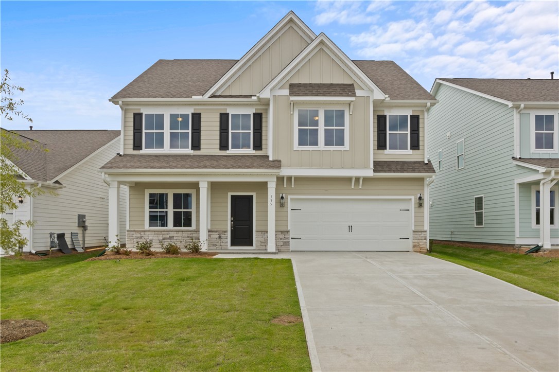 555 Hydrangea Street, Unit LOT 47 Seneca, SC 29678 - Photo 1 of 38 A classic two-story residence with a welcoming front porch and a paved driveway leading to an attached garage.