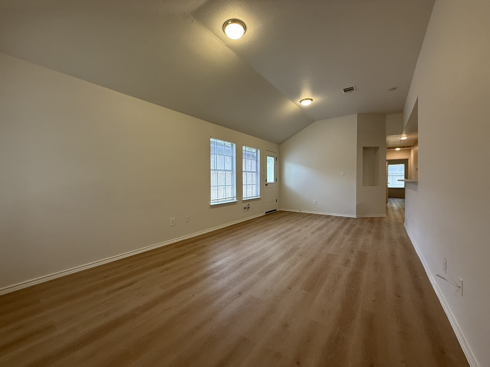 1209 Armadillo Road, Unit A Austin, TX 78745 - Photo 4 of 15 Spare room with lofted ceiling, light wood-style flooring, and healthy amount of natural light