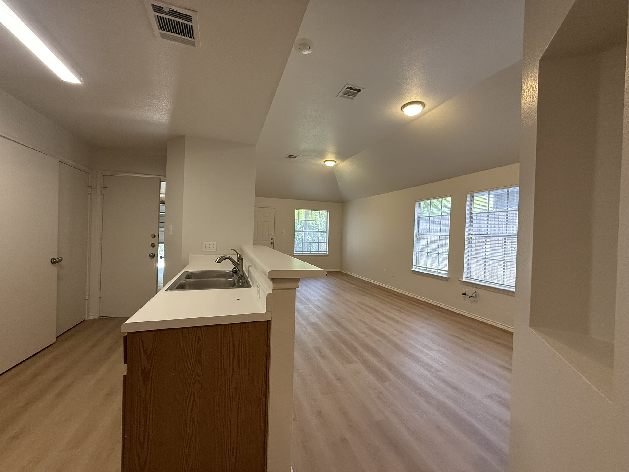 1209 Armadillo Road, Unit A Austin, TX 78745 - Photo 15 of 15 Kitchen featuring open floor plan, light countertops, light wood-style floors, and lofted ceiling