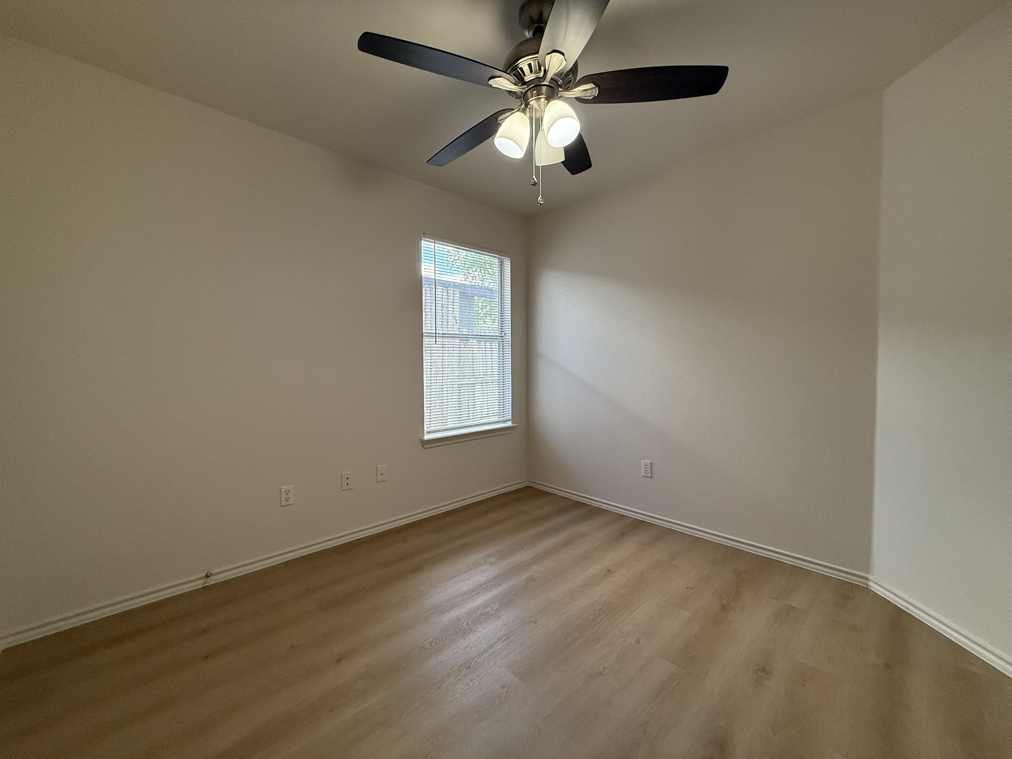 1209 Armadillo Road, Unit A Austin, TX 78745 - Photo 9 of 15 Spare room with light wood-style floors and a ceiling fan