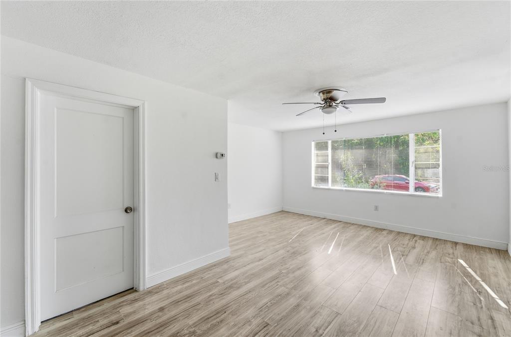 1615 Northeast 9th Street Ocala, FL 34470 - Photo 17 of 24 a view of an empty room with a window and wooden floor