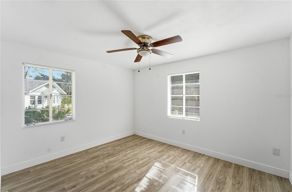 1615 Northeast 9th Street Ocala, FL 34470 - Photo 18 of 24 a view of empty room with wooden floor and fan