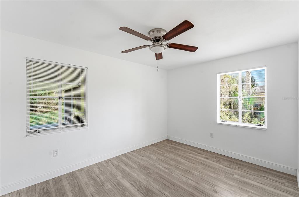 1615 Northeast 9th Street Ocala, FL 34470 - Photo 22 of 24 a view of empty room with wooden floor and fan