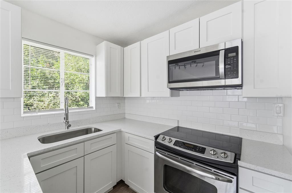 1615 Northeast 9th Street Ocala, FL 34470 - Photo 9 of 24 a kitchen with appliances cabinets and a window