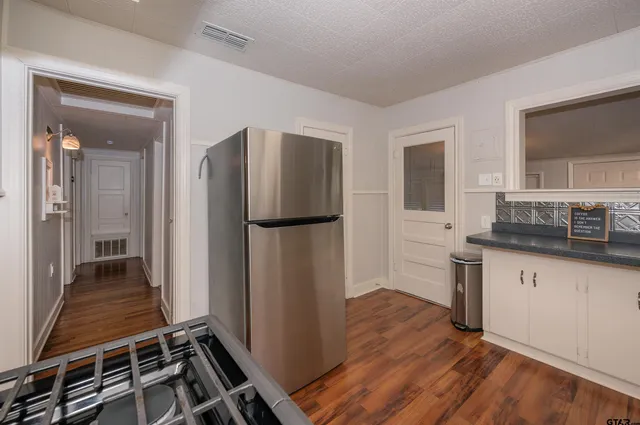 a kitchen with kitchen island a counter top space a sink and a refrigerator