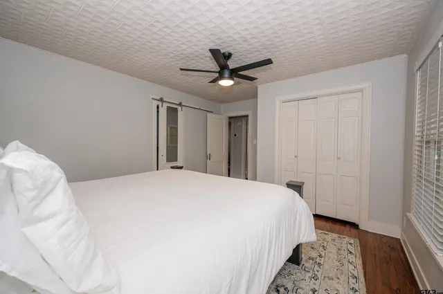 a bedroom with a bed and a chandelier