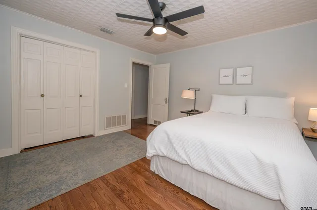 a bedroom with a bed and a ceiling fan