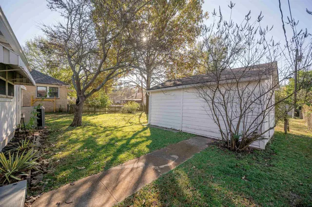 a view of a yard with a house and large tree