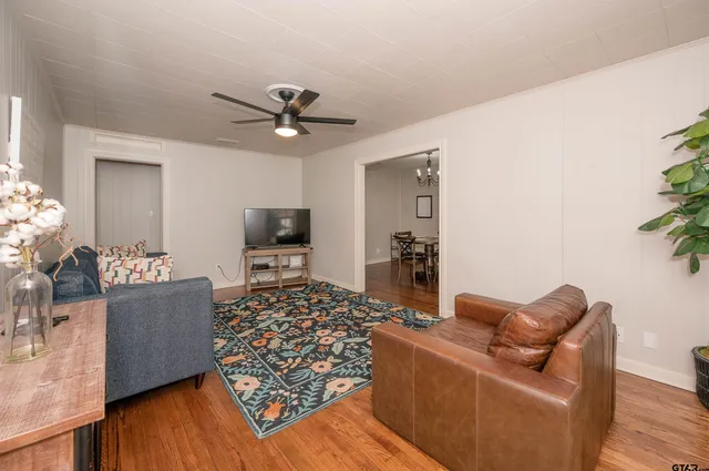 a living room with furniture and a flat screen tv