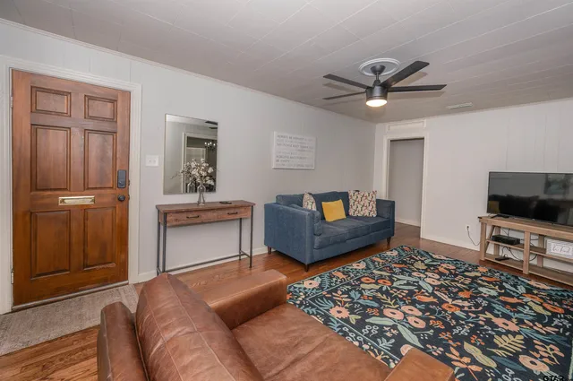a living room with furniture and a flat screen tv