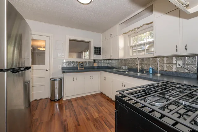 a kitchen with a stove a sink and a refrigerator