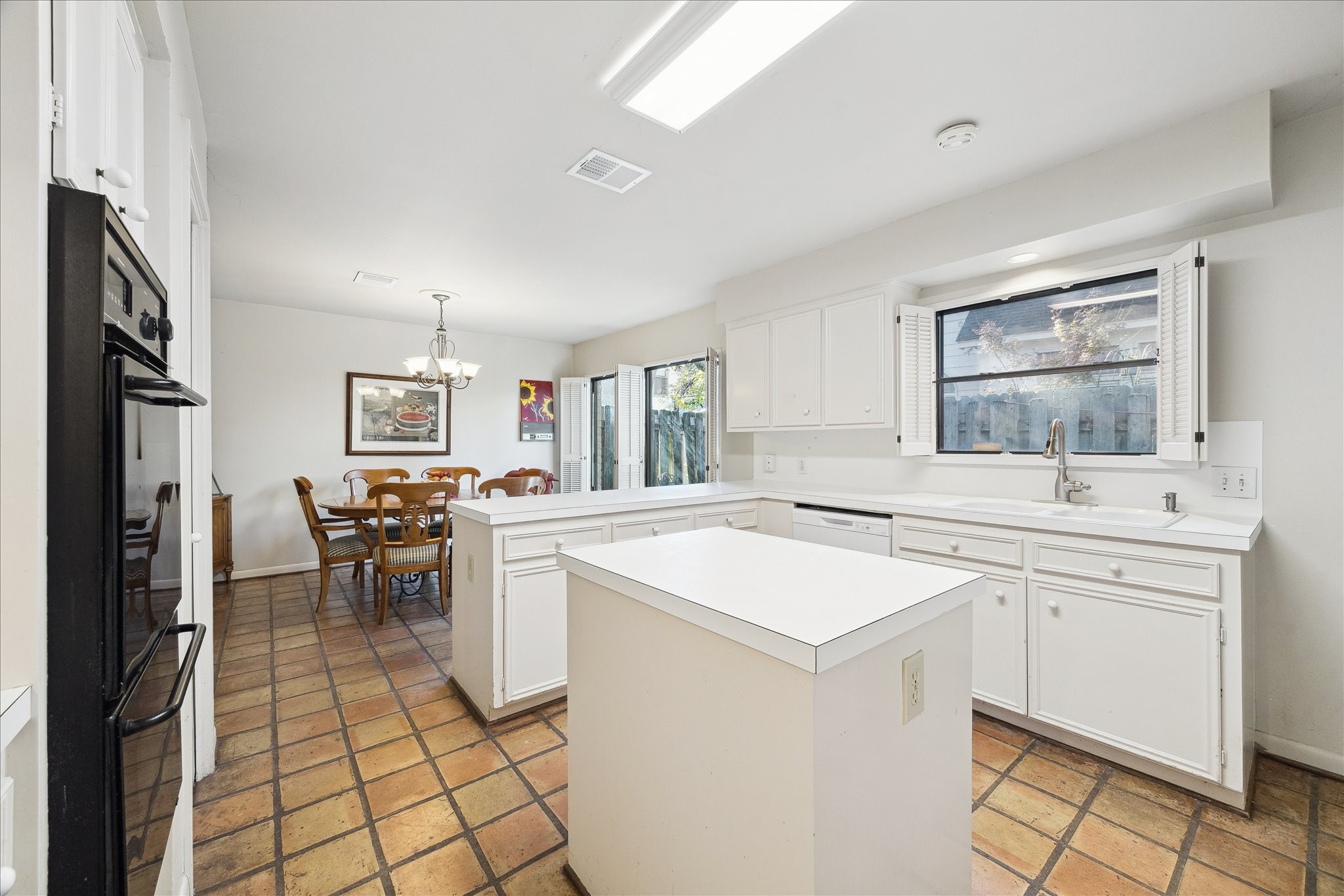 306 Commodore Way Houston, TX 77079 - Photo 13 of 33 a kitchen with a sink a stove a refrigerator and white cabinets