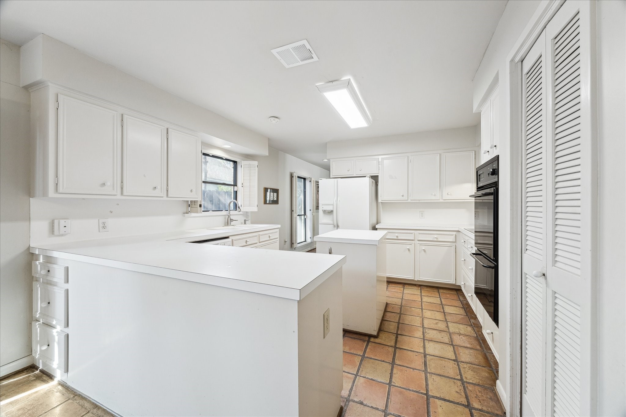 306 Commodore Way Houston, TX 77079 - Photo 14 of 33 a kitchen with white cabinets and white appliances