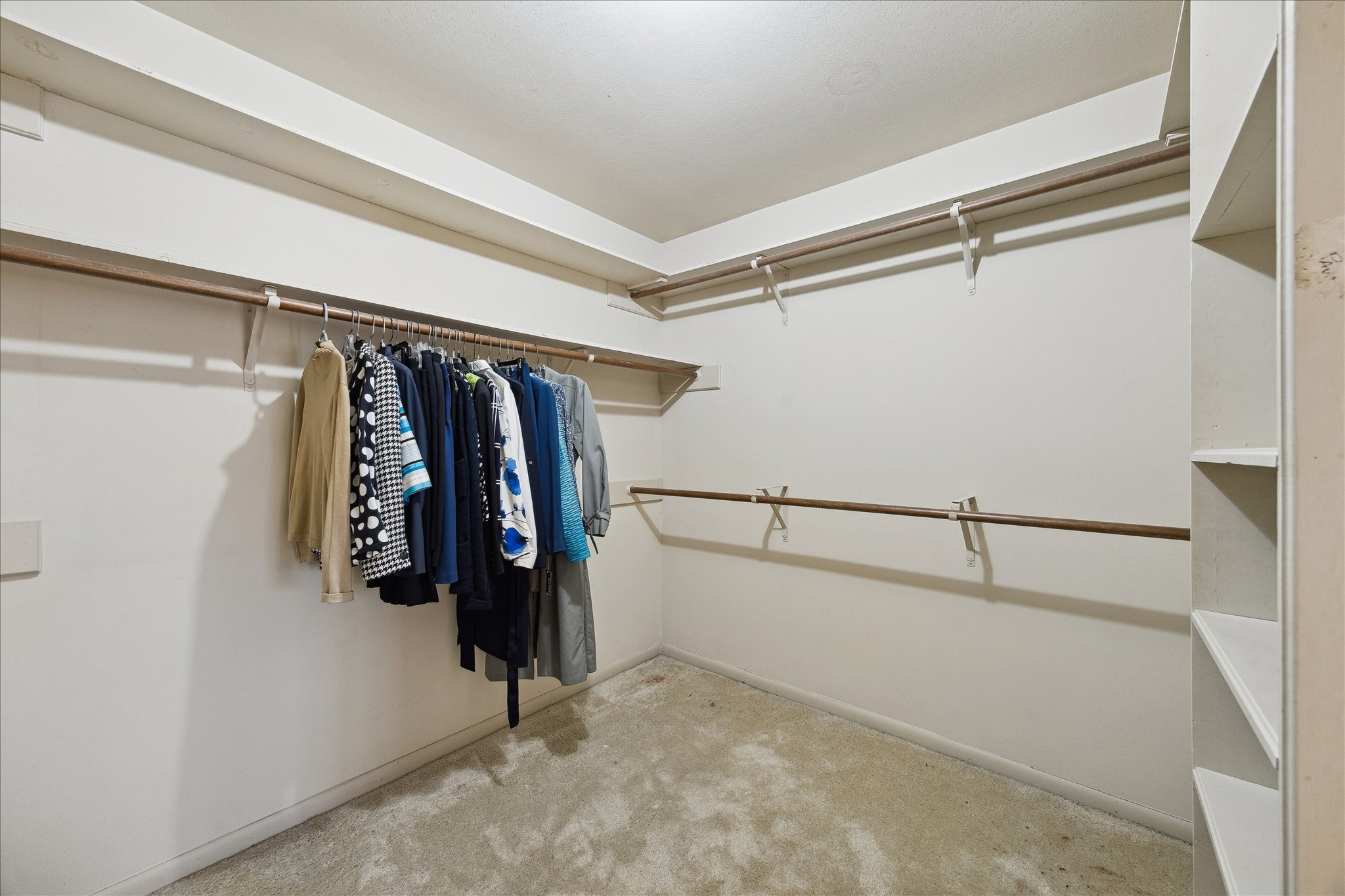 306 Commodore Way Houston, TX 77079 - Photo 22 of 33 a view of walk in closet with clothes